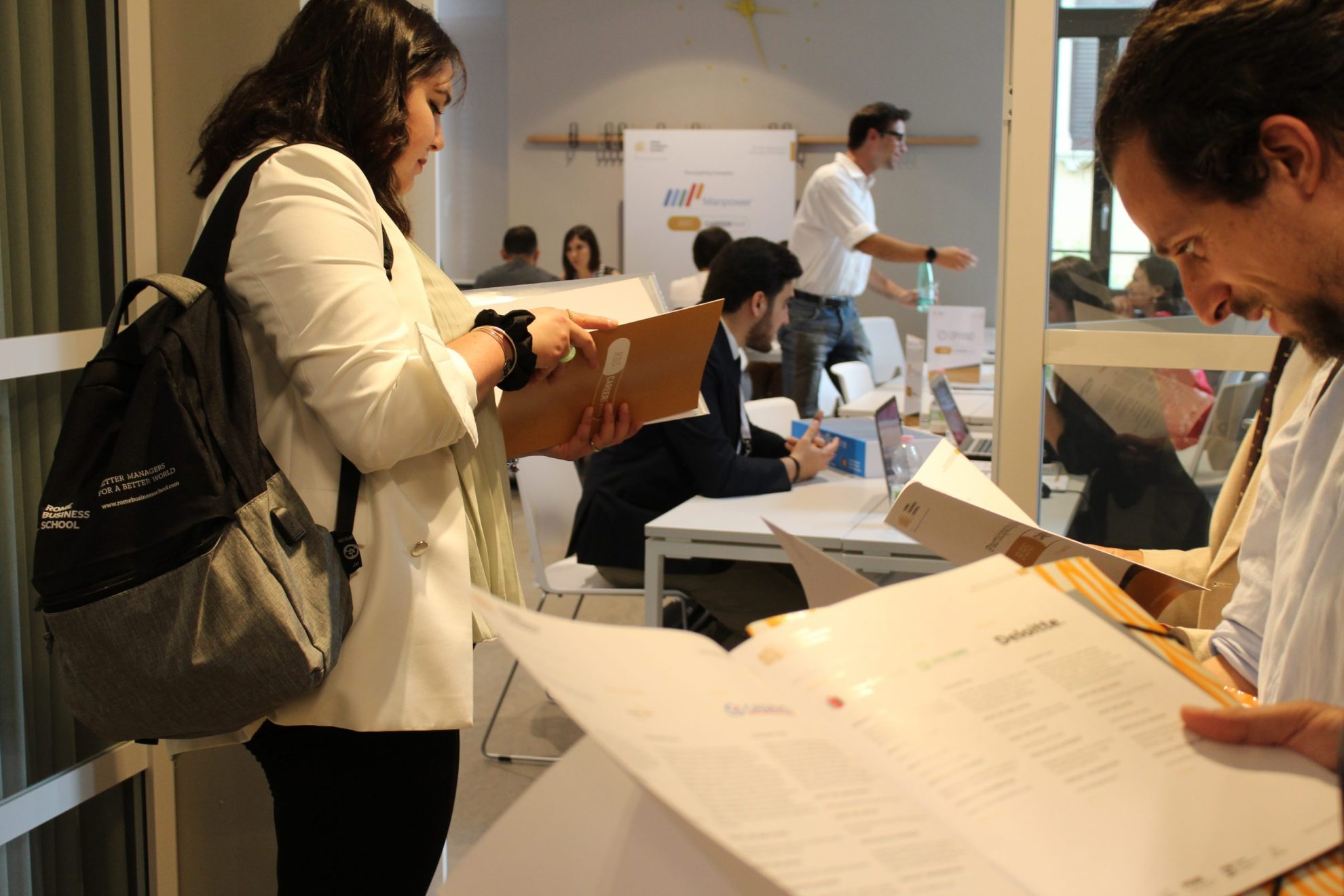 MBA students reading careers fair booklets